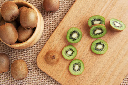 Ripe kiwi fruit on kitchen board