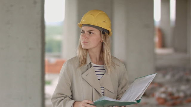Female engineer is angry and upset reading construction plan
