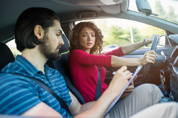 Driving school. Stressed and disapointed young woman failed on driving test.