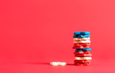 Stack of red, white and blue cookies on a red background
