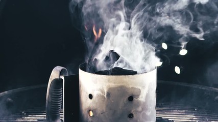 Wood chips flame and smoke on charcoal grill, slow motion