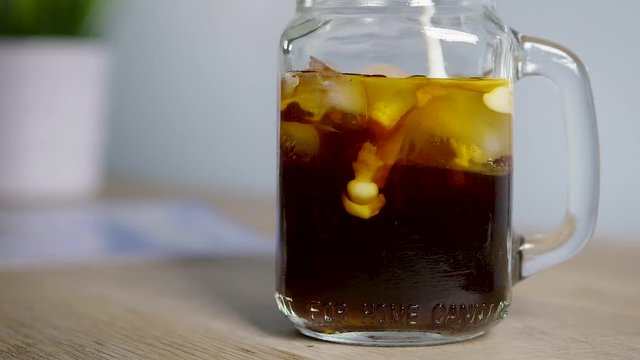 Creamer Pouring Into Cold Brew Coffee In Slow Motion
