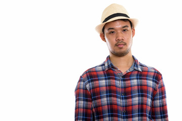 Studio shot of young Asian man 