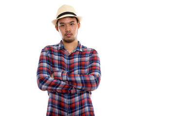 Studio shot of young Asian man with arms crossed