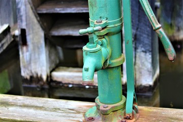 Fototapeta na wymiar Antique Green Water Pump