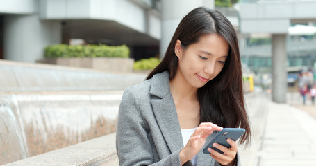 Businesswoman use of smart phone in Hong Kong