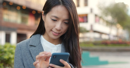 Businesswoman use of smart phone in Hong Kong