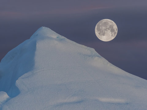 Greenland. Centuries-old thicknesses of glaciers. Icebergs of unusual forms. Icebergs and full moon