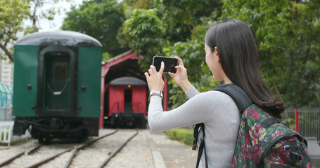 Tourist travel and taking phone on cellphone at train station