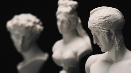 Focus changing between many famous roman sculptures busts made of marble. Closeup shots with focus pull. - Powered by Adobe