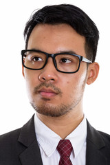 Face of young Asian businessman thinking while wearing eyeglasse
