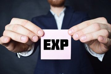 A businessman shows an inscription:EXP