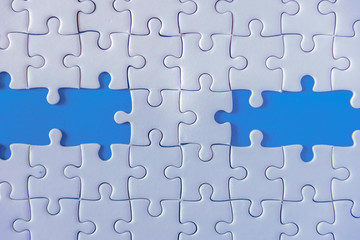 Jigsaw puzzle white on blue background.