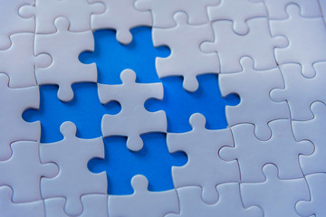 Jigsaw with one piece missing revealing