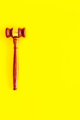 Lawyer or attorney concept. Judge gavel on yellow background top view copy space