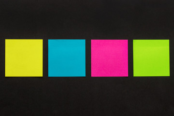 multicolored stickers on black background
