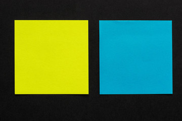 yellow and blue stickers on black background