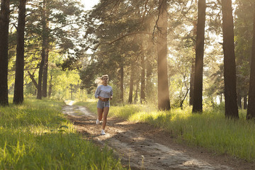 Obraz premium young beautiful girl running, evening jogging, sport and fitness 