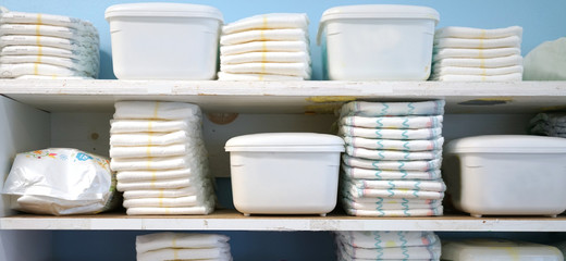diapers and container boxes on the shelf in daycare
