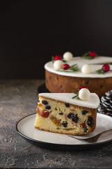 Traditional Christmas Fruit Cake pudding with marzipan and rosemary decor on plate. Copy space. Christmas concept.