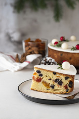 Traditional Christmas Fruit Cake pudding with marzipan and rosemary decor on plate. Copy space. Christmas concept.