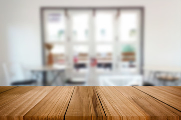 Selected focus empty brown wooden table and Coffee shop blur background with bokeh image. for your photomontage or product display