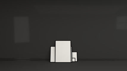 Blank white posters in black frames standing on the floor