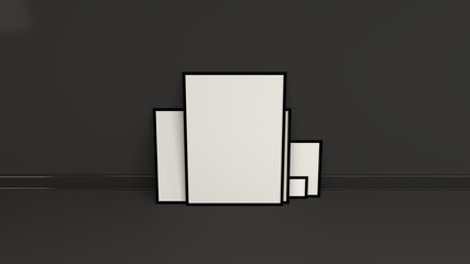Blank white posters in black frames standing on the floor