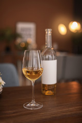 Glass and bottle of wine on table in restaurant