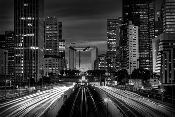 Fototapeta premium Modern city at night with cars light lines.