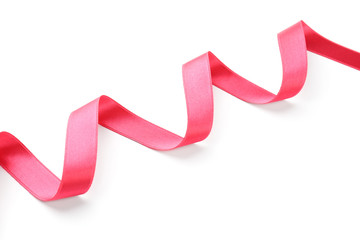 Simple pink ribbon on white background. Festive decoration