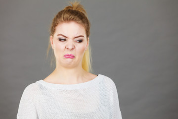 Woman having disgusted face expression