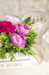 Bouquet of peonies. Peonies and roses. Peonies in a wooden box