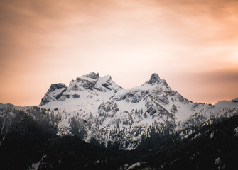 Fototapeta na wymiar Orange alpen glow behind Sky Pilot Mountain in British Columbia