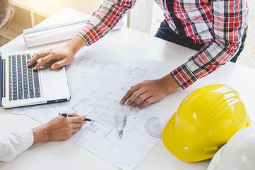 Architect or Engineer meeting working with partner on blueprint for architectural project in...