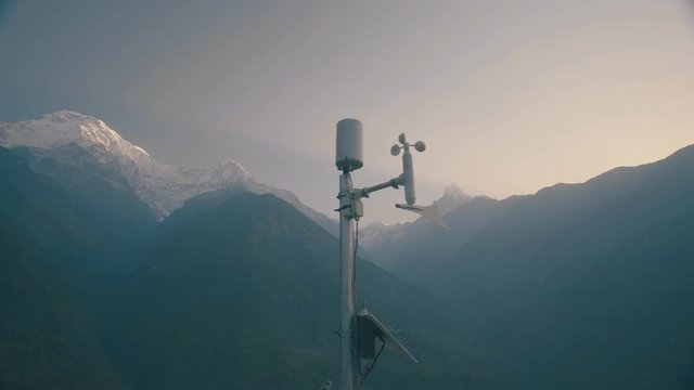 Anemometer Weather station working against Huge Mountain Covered Snow in Background in Morning