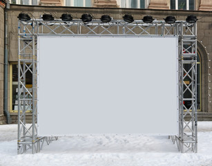 Information banner is made of lattice tubular metal construction and installed on the street.