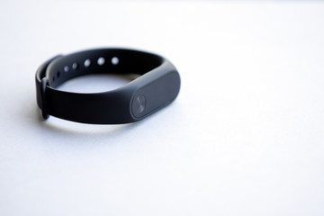 Fitness tracker or smartwatch on table with copy space.