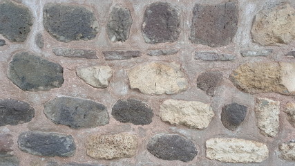 Weathered stained old stone brick wall. wall texture and background