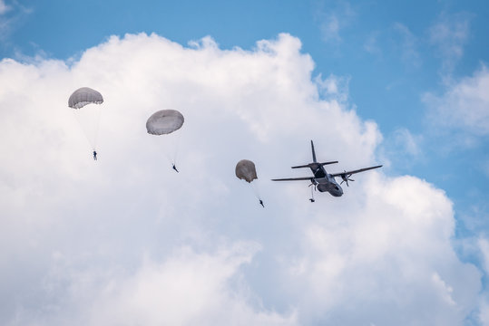 Skydivers are jumping out of a plane.