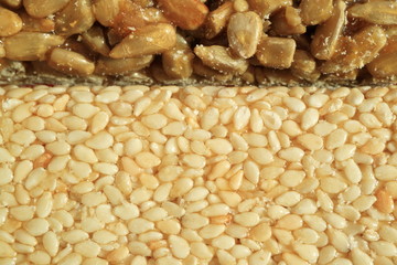 Picture of a candy. Sesame and Sunflower in sugar glaze.