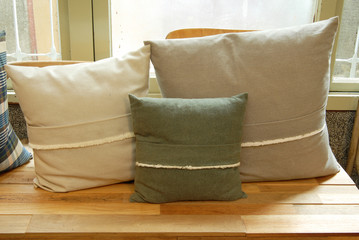 Stacked pillows  on a wooden bench     