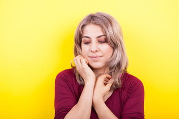 Attractive young woman portrait on yellow background