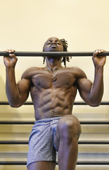 Fototapeta na wymiar Bodybuilder Doing Pull-Ups in the Gym