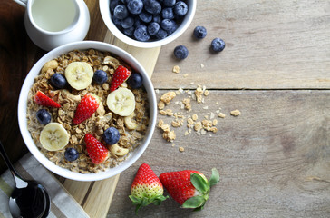 Healthy breakfast, Bowl of yogurt with granola and Fresh fruit on Wood background