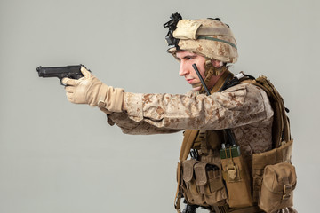 Soldier in camouflage holding rifle