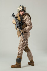 Soldier in camouflage holding rifle