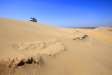 Fototapeta na wymiar Off-road vehicle traveling in the desert