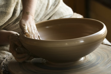 Obraz na płótnie Canvas Professional female potter working with clay 