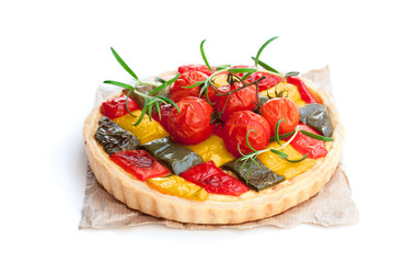 Vegetarian  quiche with colored pepper and cherry tomatoes isolated on white